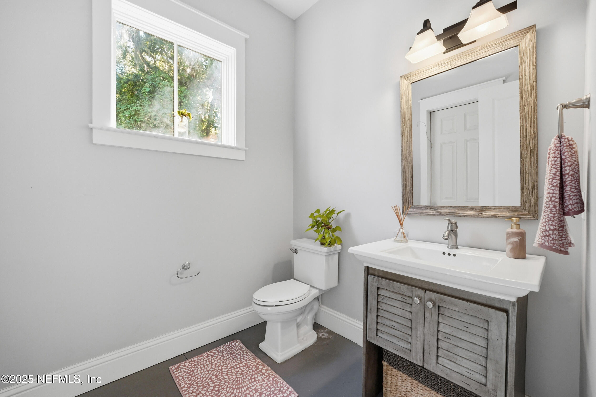 4745 Palm Valley Road Ponte Vedra Beach, FL 32082 - Photo 77 of 104 a bathroom with a sink a toilet and a mirror