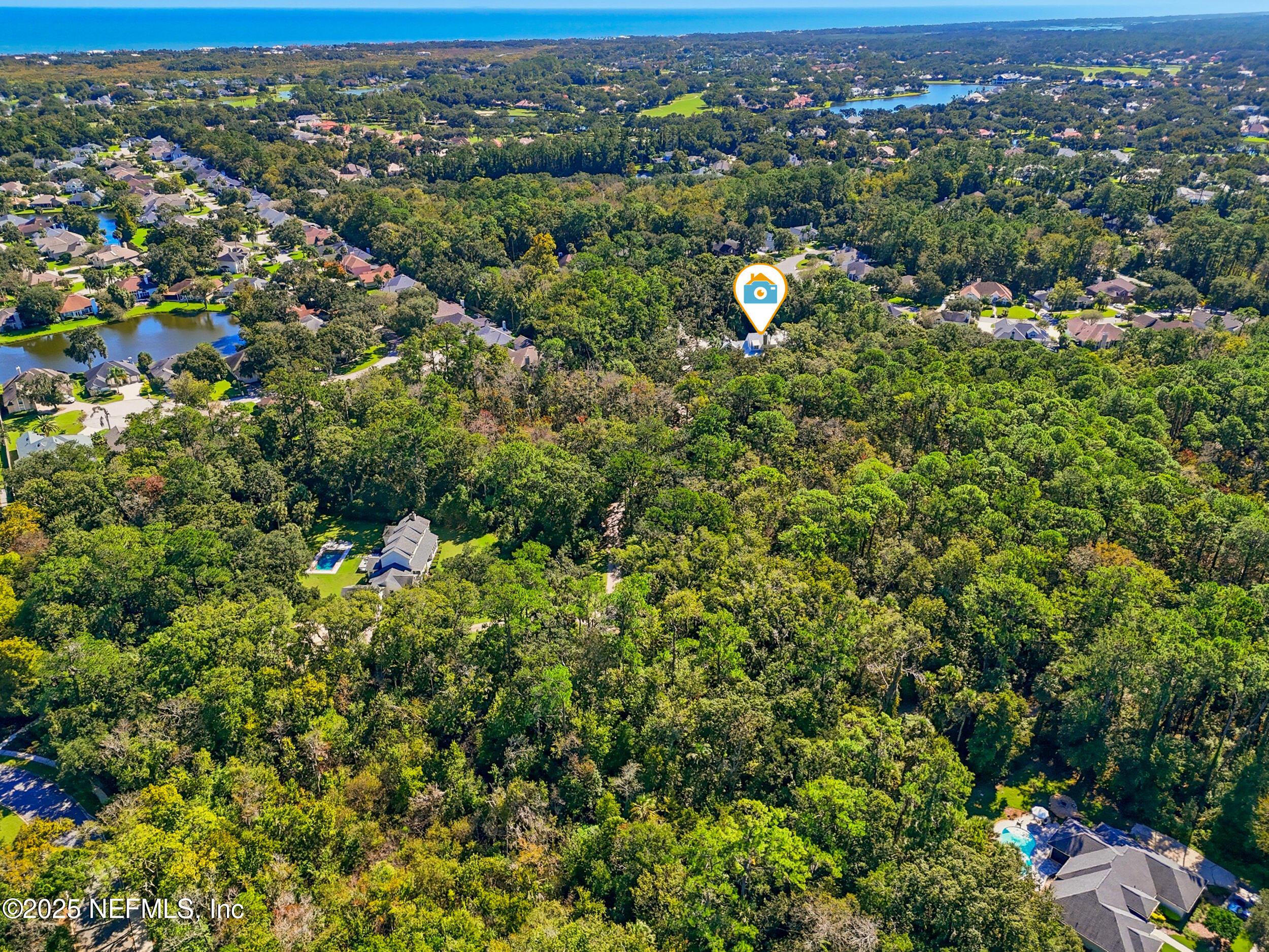 4745 Palm Valley Road Ponte Vedra Beach, FL 32082 - Photo 100 of 104 an aerial view of a houses with a lush green hillside