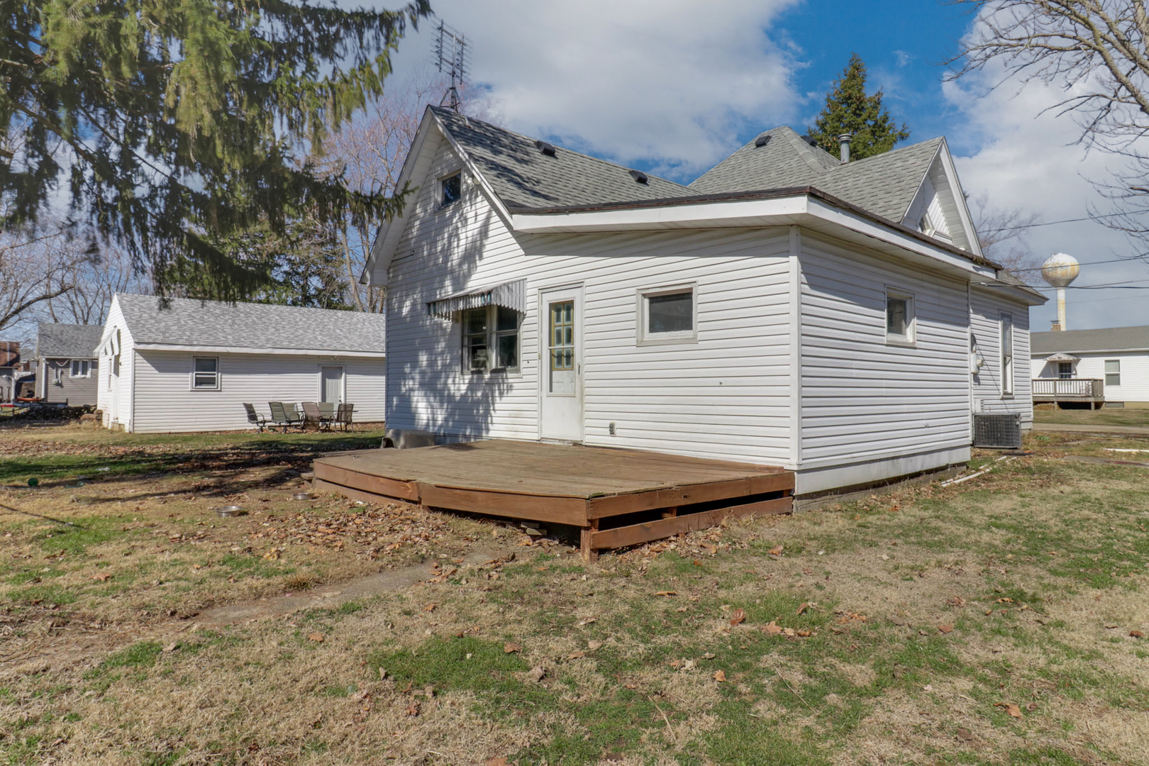 207 Field Street Secor, IL 61771 - Photo 24 of 30 a view of a white house with a yard and large tree