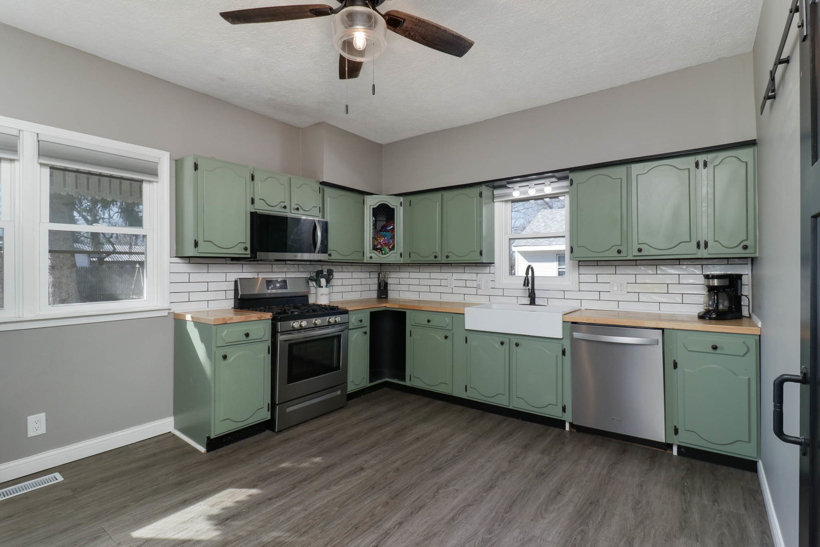 207 Field Street Secor, IL 61771 - Photo 8 of 30 a kitchen with a sink stainless steel appliances and wooden floor