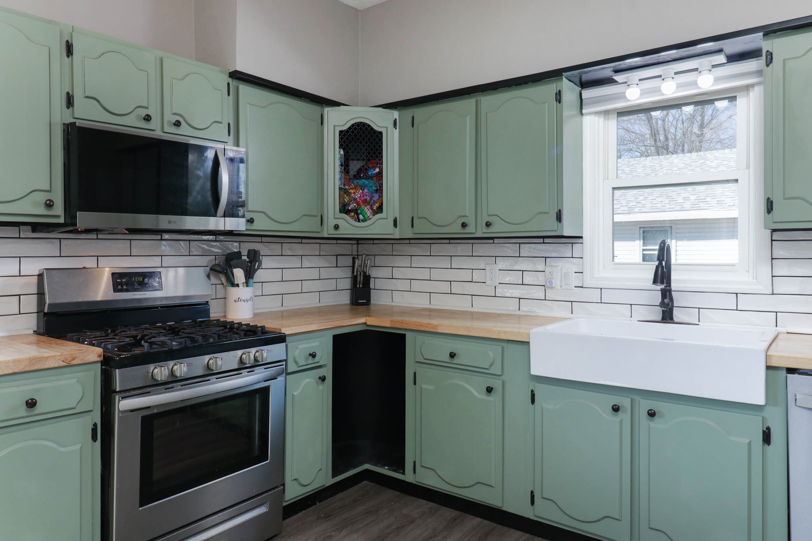 207 Field Street Secor, IL 61771 - Photo 9 of 30 a kitchen with stainless steel appliances granite countertop a sink stove and microwave