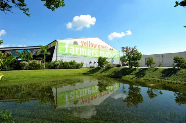 a view of a fountain in front of a house with a yard