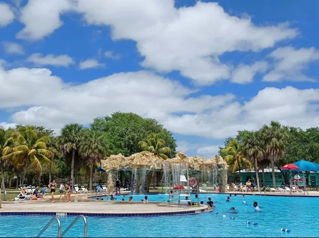 a view of swimming pool with outdoor seating and deck