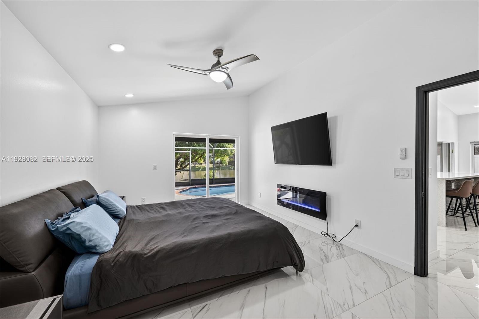 720 Rock Hill Avenue Davie, FL 33325 - Photo 11 of 27 a bedroom with a bed and a flat screen tv