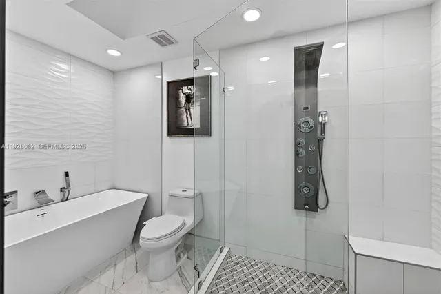 a bathroom with a toilet sink and shower