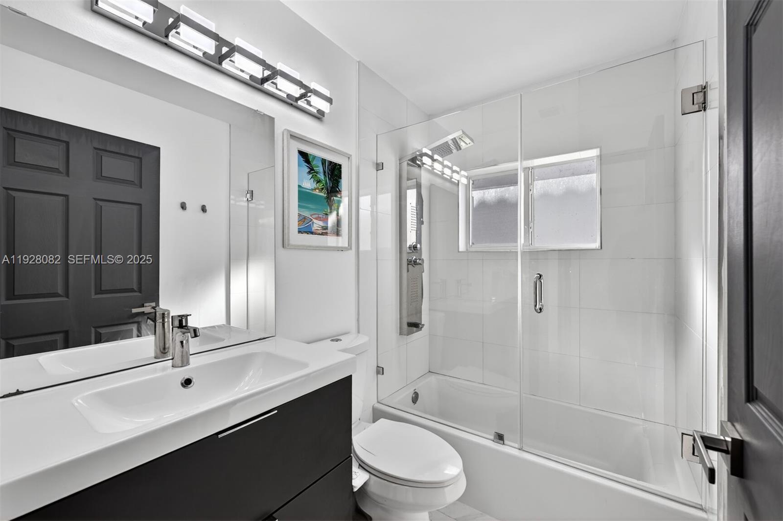 720 Rock Hill Avenue Davie, FL 33325 - Photo 15 of 27 a bathroom with a double vanity sink toilet mirror and shower