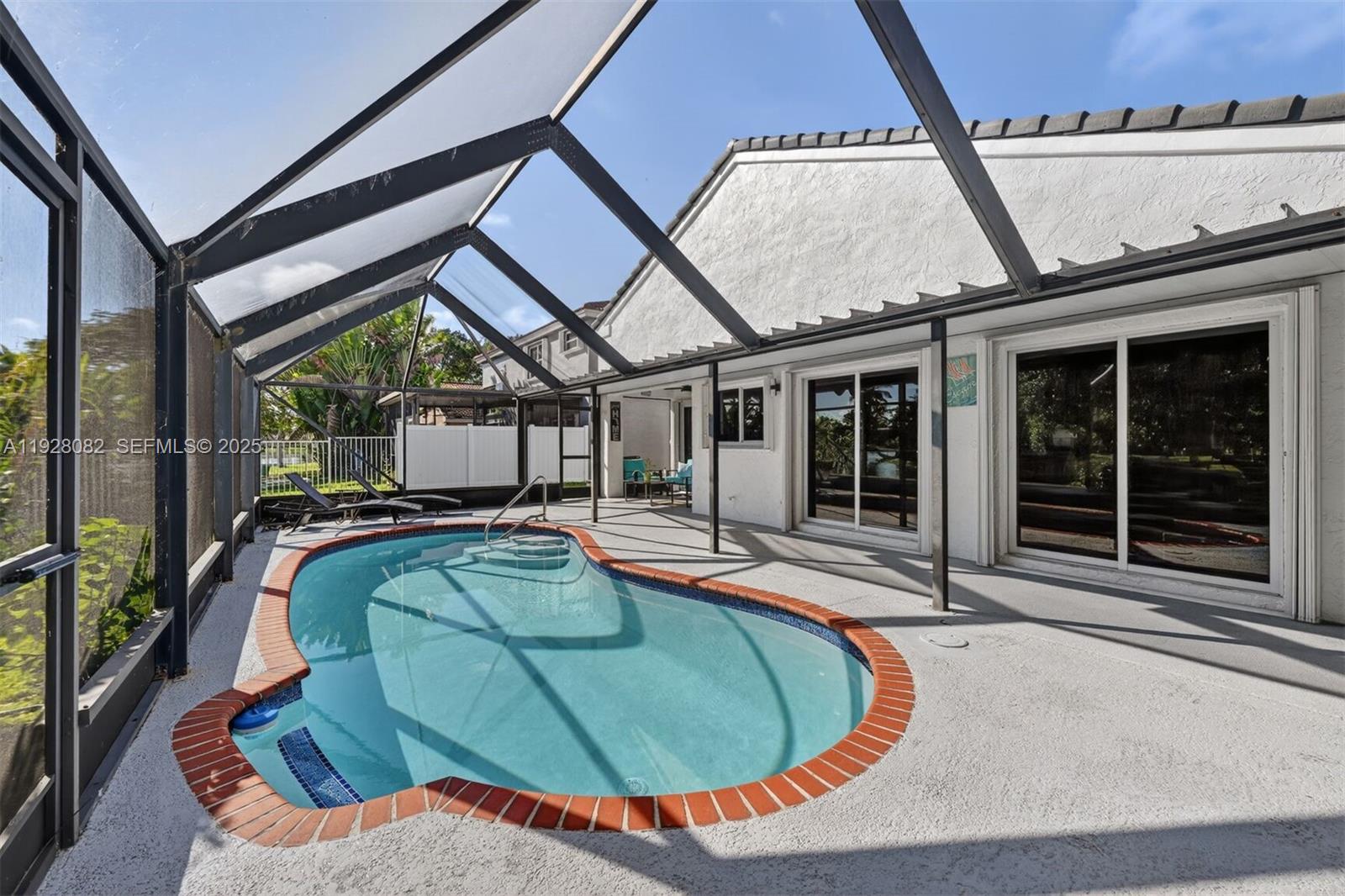 720 Rock Hill Avenue Davie, FL 33325 - Photo 17 of 27 a view of a swimming pool with an outdoor seating