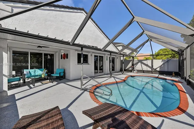 a view of a patio with table and chairs under an umbrella