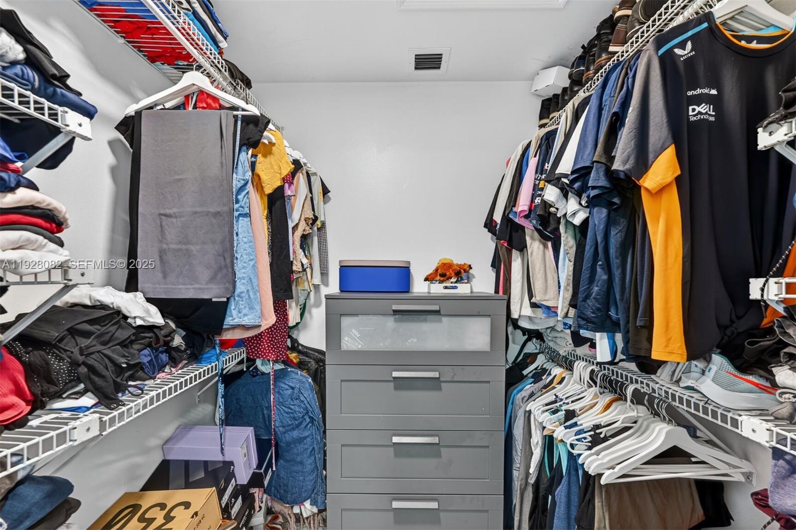 720 Rock Hill Avenue Davie, FL 33325 - Photo 26 of 27 a view of walk in closet with clothes and shoes