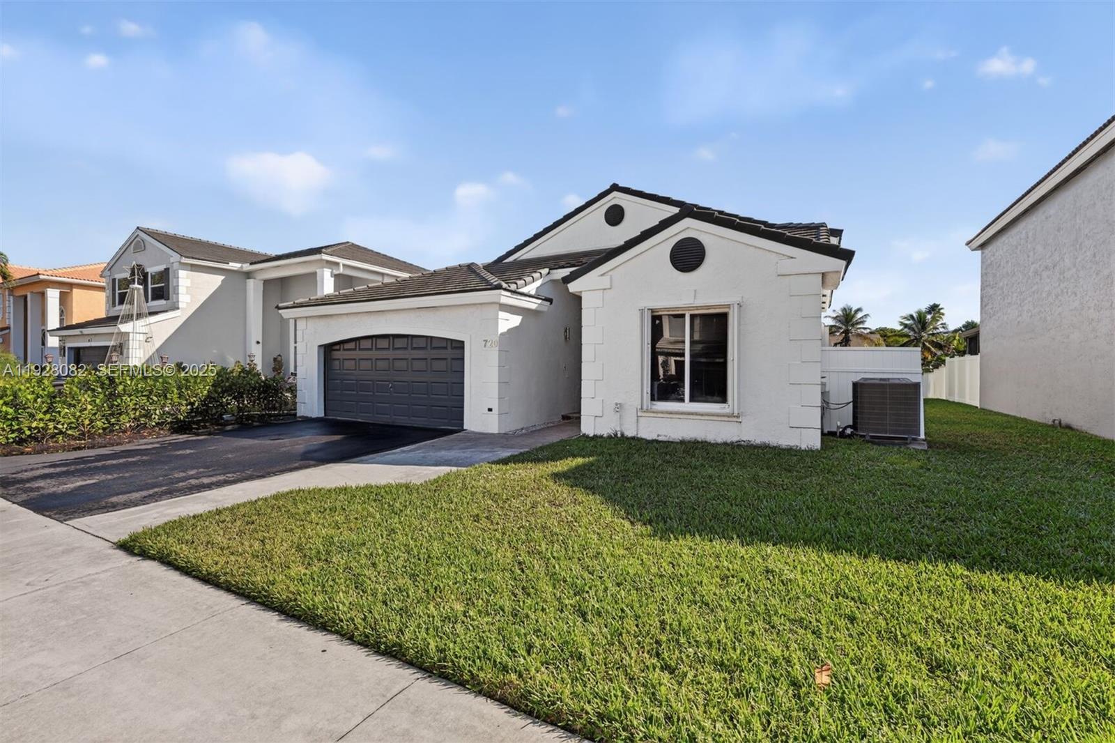 720 Rock Hill Avenue Davie, FL 33325 - Photo 27 of 27 a front view of a house with a yard