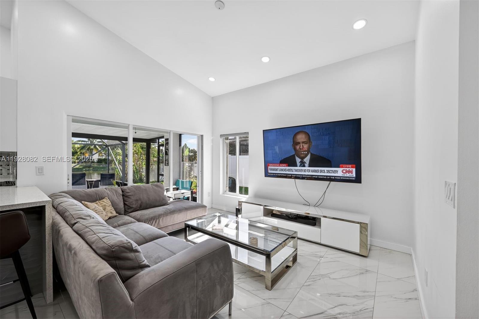 720 Rock Hill Avenue Davie, FL 33325 - Photo 3 of 27 a living room with furniture and a flat screen tv