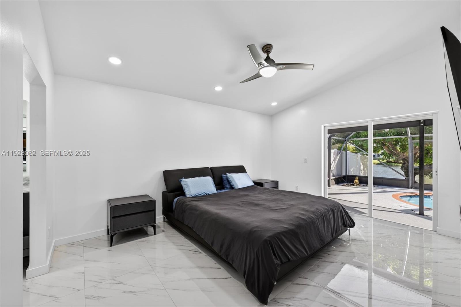 720 Rock Hill Avenue Davie, FL 33325 - Photo 10 of 27 a spacious bedroom with a bed and glass door