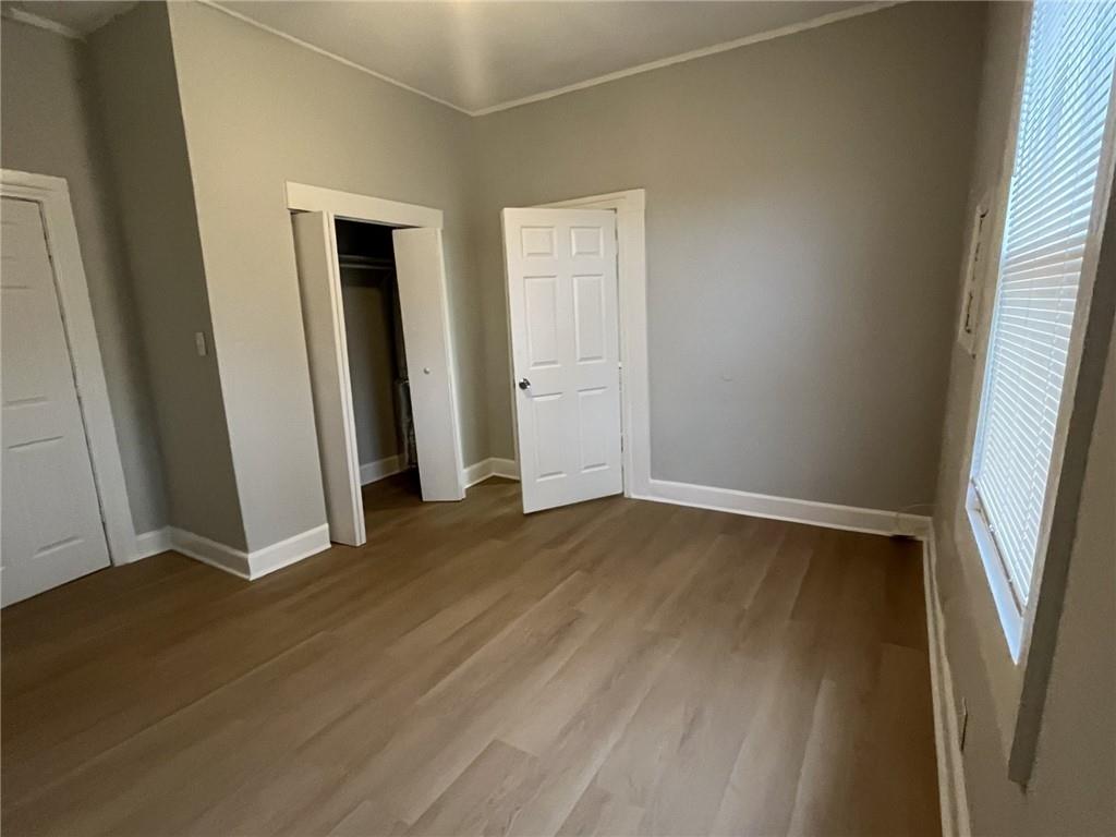 202 Cheatham Street Griffin, GA 30223 - Photo 6 of 11 an empty room with wooden floor and window