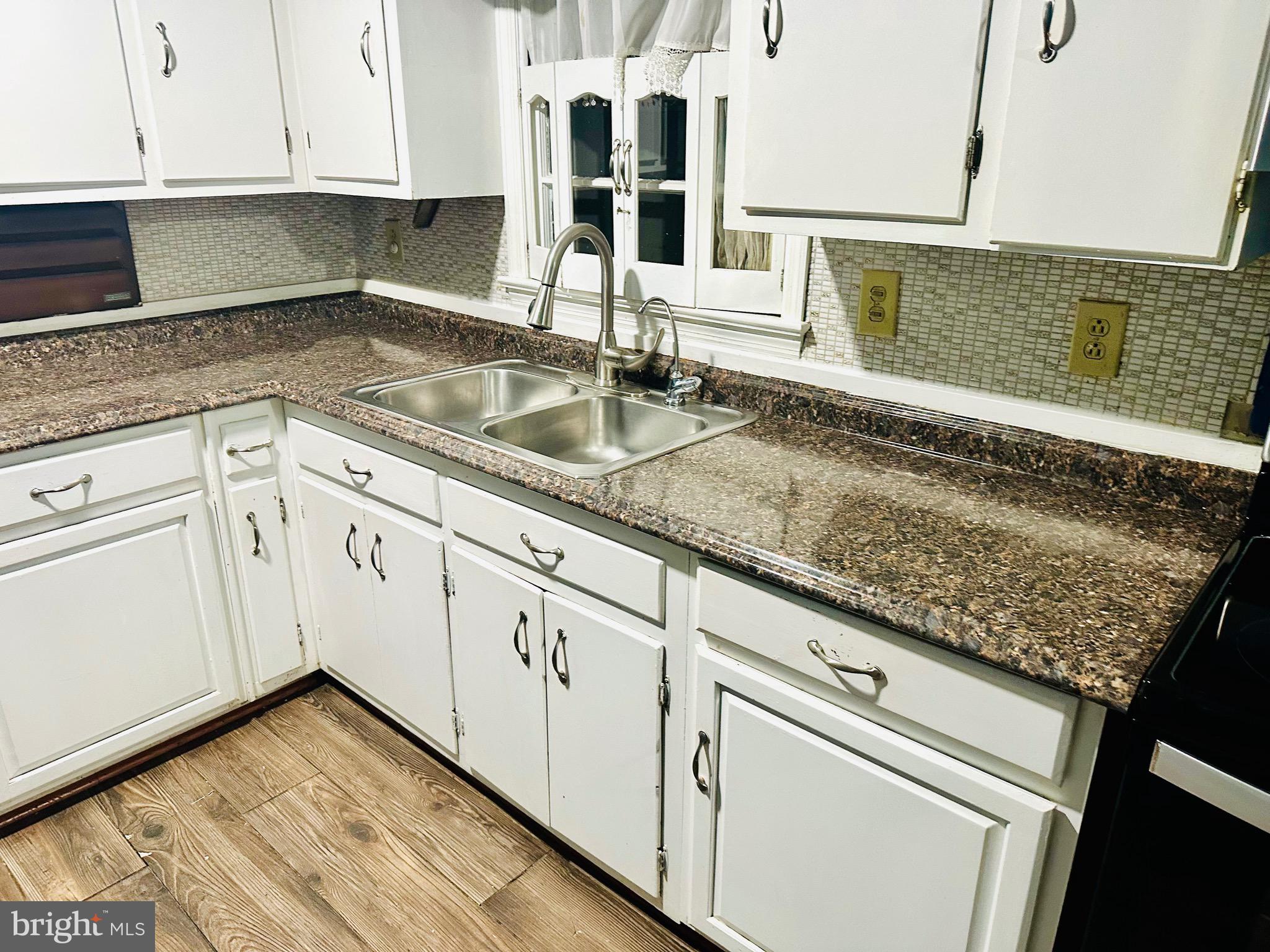 323 Russelcroft Road Winchester, VA 22601 - Photo 33 of 40 a kitchen with granite countertop a sink and cabinets