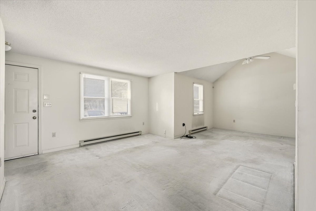 87 Victoria Heights Road, Unit 87 Boston, MA 02136 - Photo 3 of 32 an empty room with windows