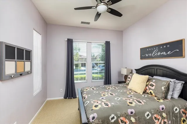 a view of a white house next to a yard