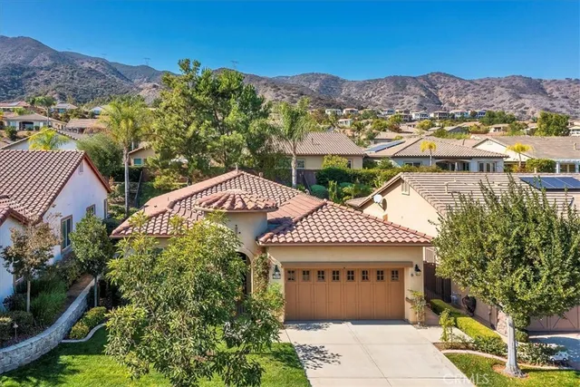 a front view of a house with a yard and a garage