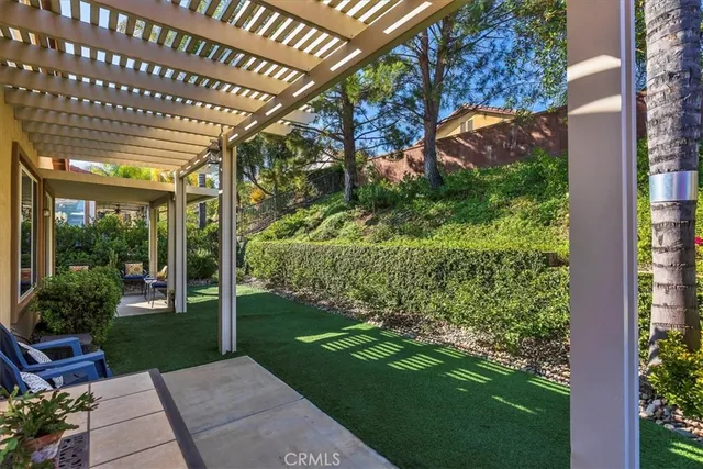 a living room with fireplace furniture and a large window