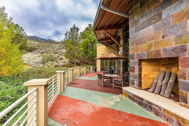 a view of a patio with table and chairs and potted plants