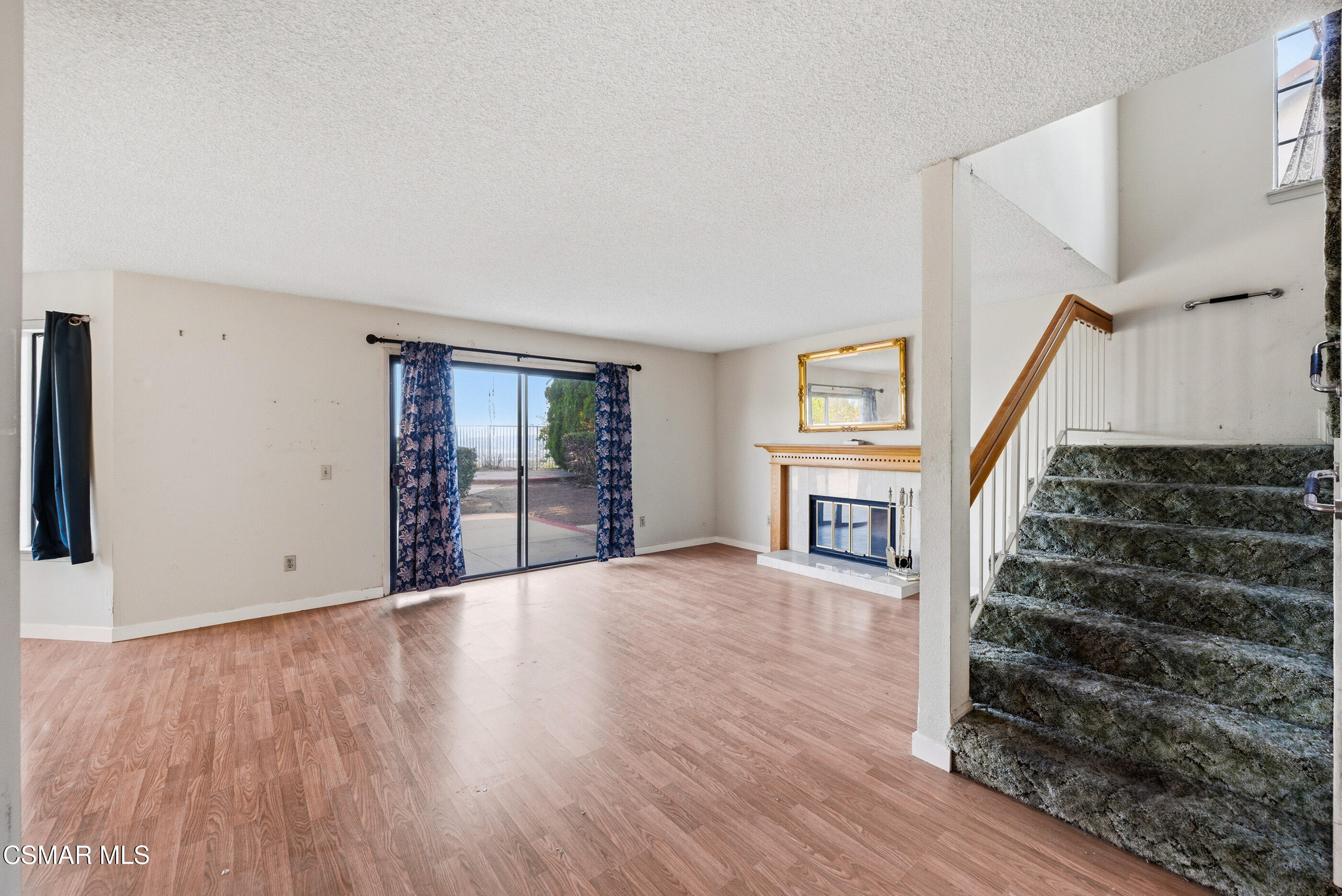 12036 Shadow Ridge Way Porter Ranch, CA 91326 - Photo 7 of 35 a view of an empty room with wooden floor and stairs