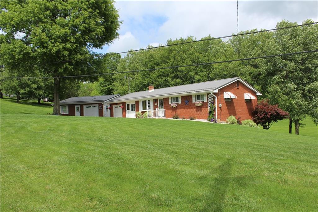 928 Old Ridge Road Avella, PA 15312 - Photo 2 of 49 a aerial view of a house next to a big yard and large trees