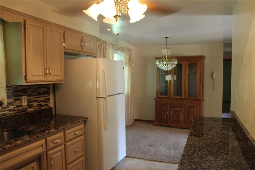 928 Old Ridge Road Avella, PA 15312 - Photo 23 of 49 a kitchen with cabinets a refrigerator and a stove top oven