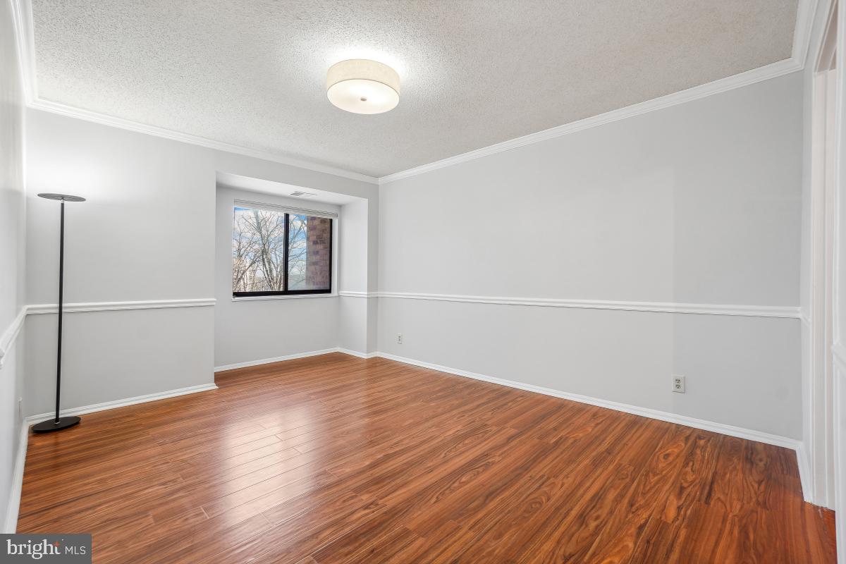 5903 Mt Eagle Drive, Unit 314 Alexandria, VA 22303 - Photo 13 of 44 an empty room with wooden floor and windows