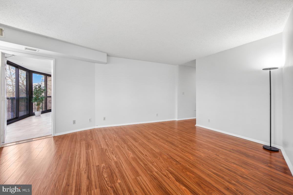 5903 Mt Eagle Drive, Unit 314 Alexandria, VA 22303 - Photo 25 of 44 a view of an empty room with wooden floor and a window