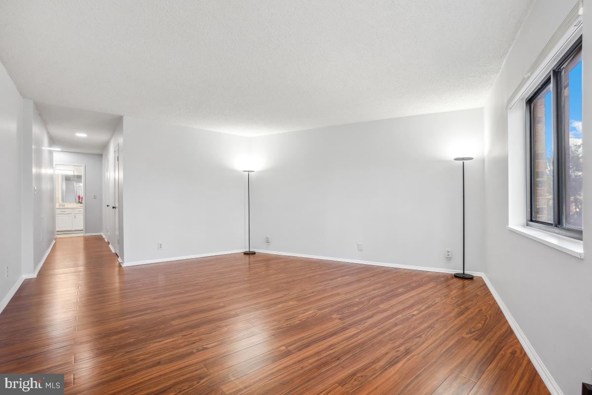 5903 Mt Eagle Drive, Unit 314 Alexandria, VA 22303 - Photo 26 of 44 a view of an empty room with wooden floor and a window