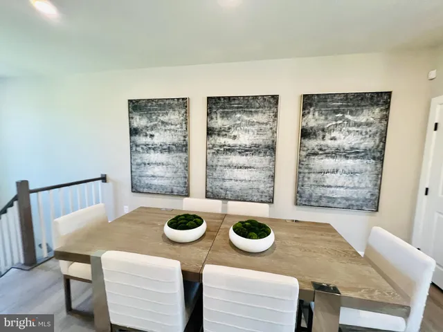 a view of a dining room with furniture and a window