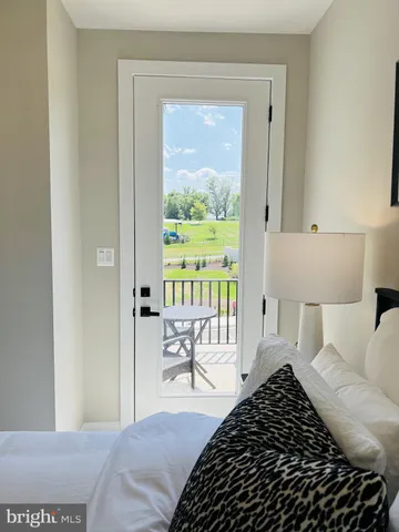 a bedroom with a bed and a large window