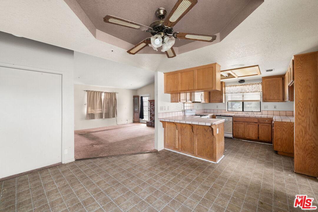 13377 Paramount Road Phelan, CA 92371 - Photo 11 of 28 a view of a kitchen with a sink stainless steel appliances and cabinets