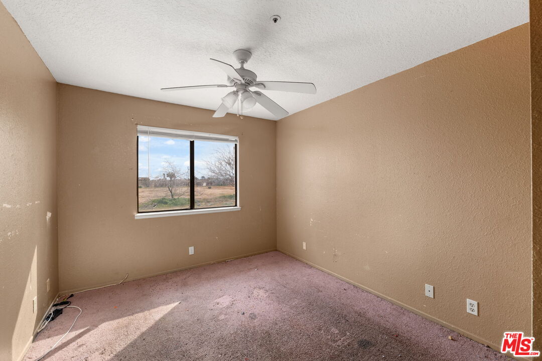 13377 Paramount Road Phelan, CA 92371 - Photo 15 of 28 a view of an empty room with a window