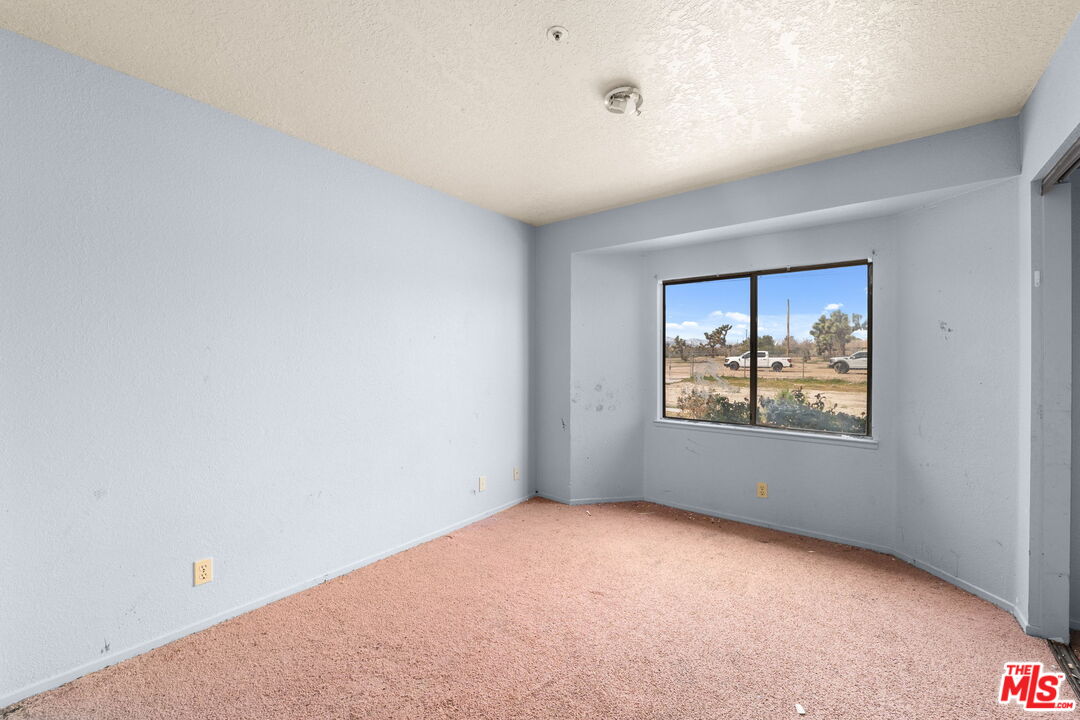 13377 Paramount Road Phelan, CA 92371 - Photo 17 of 28 an empty room with windows