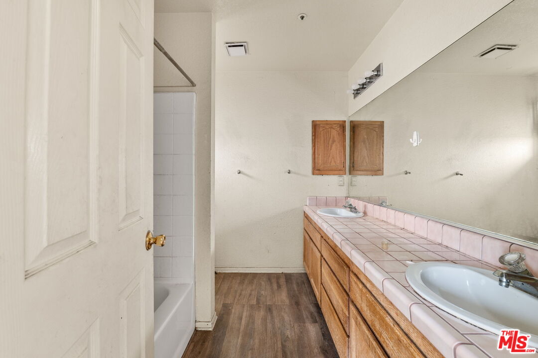 13377 Paramount Road Phelan, CA 92371 - Photo 22 of 28 a bathroom with a sink and a mirror
