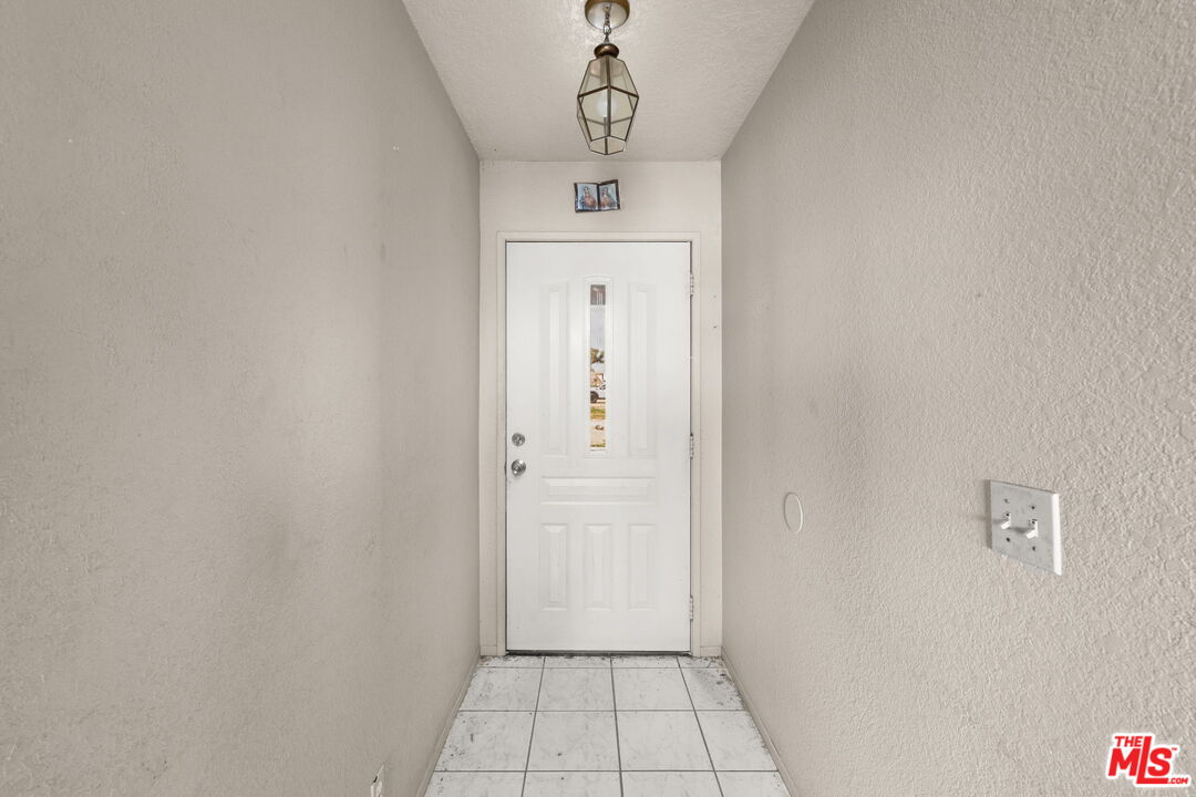 13377 Paramount Road Phelan, CA 92371 - Photo 6 of 28 a view of a hallway to a bedroom