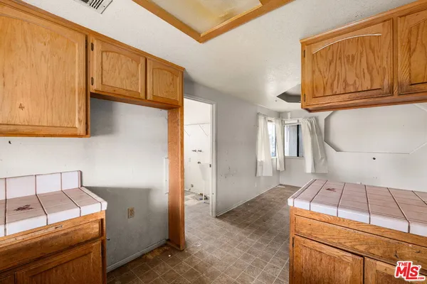 a kitchen with wooden cabinets and a stove top oven