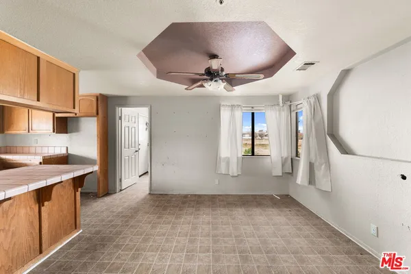 a view of a kitchen with a sink and a refrigerator