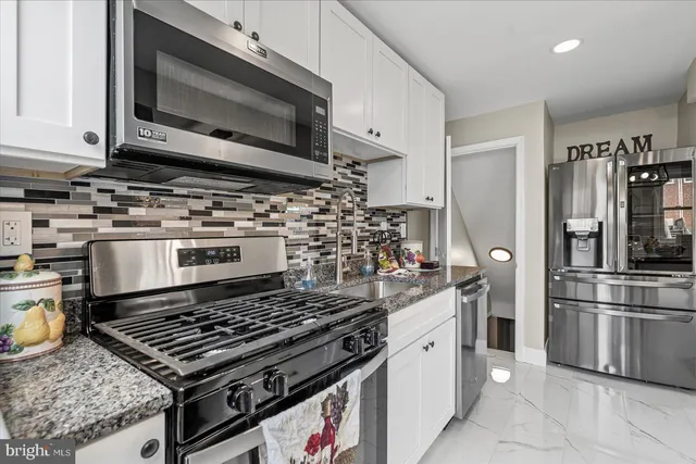 a kitchen with a stove and a microwave