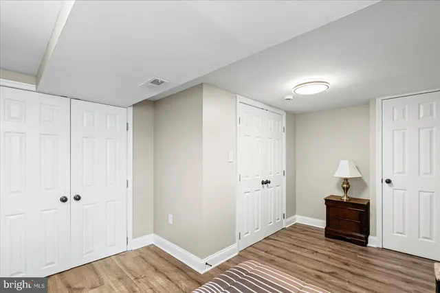 a view of a room with wooden floor and bathroom