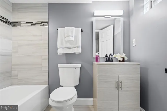 a bathroom with a sink mirror toilet and bathtub