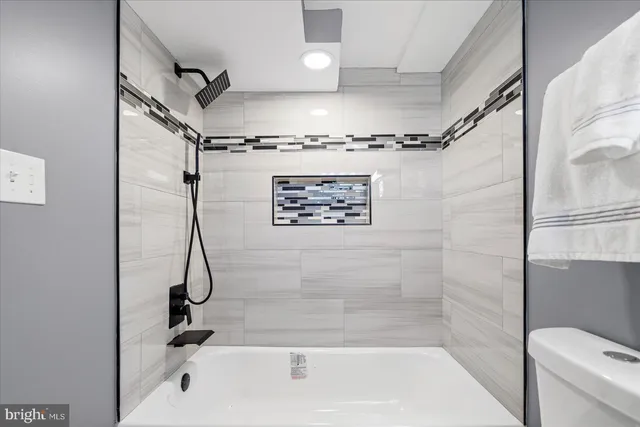 a bathroom with a shower a mirror and a shower