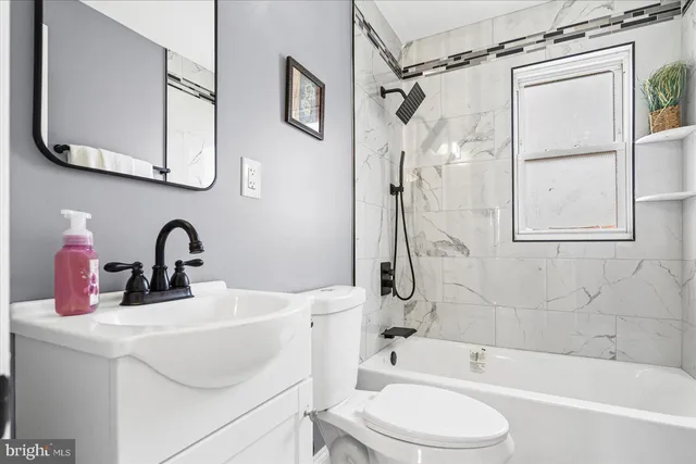 a bathroom with a sink a toilet and a bathtub