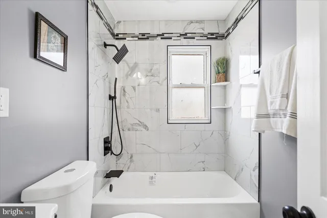 a bathroom with a bathtub a toilet and a shower