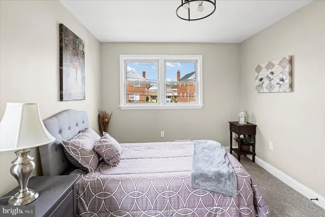 a bedroom with a bed and the view of chair