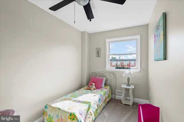 a bedroom that has a bed and a bookshelf in it