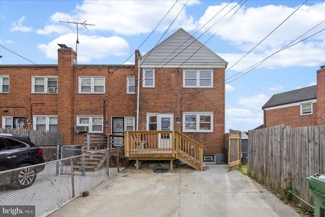 a backyard of a house with barbeque oven and outdoor seating