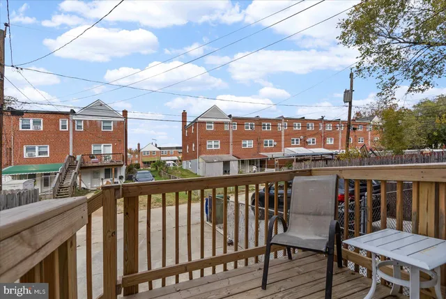 a view of a balcony with wooden chairs