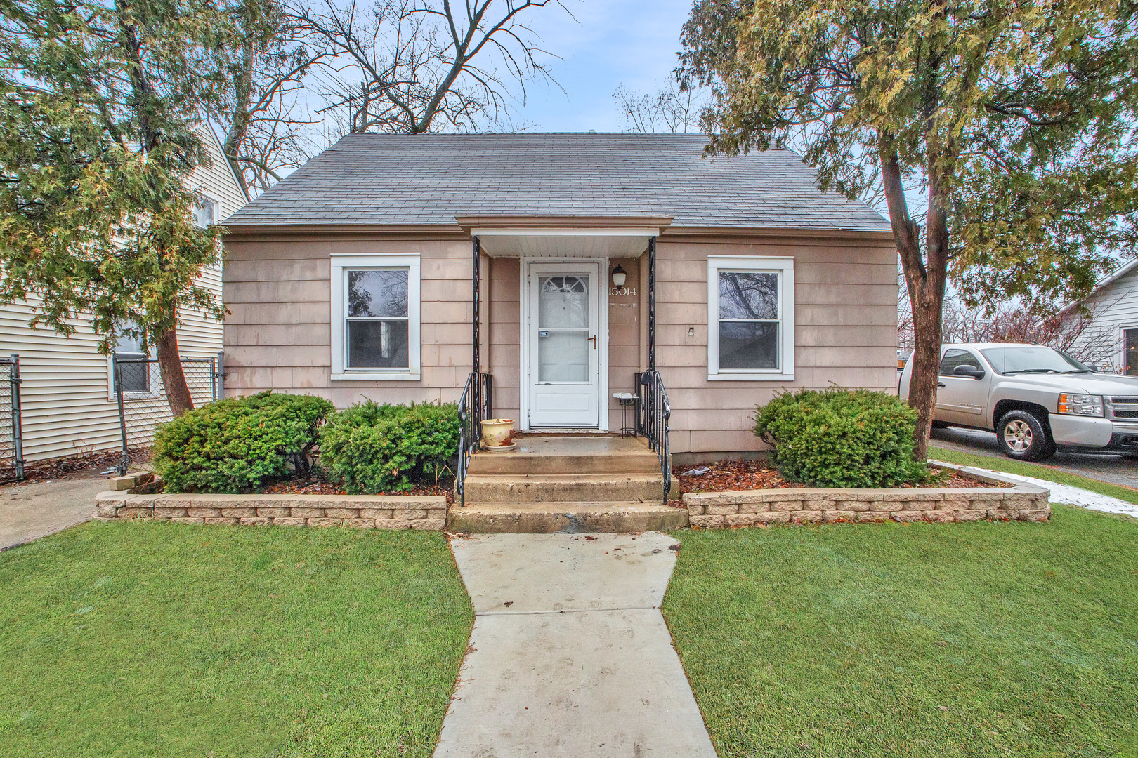 15014 Ridgeway Avenue Midlothian, IL 60445 - Photo 1 of 18 a front view of a house with a garden