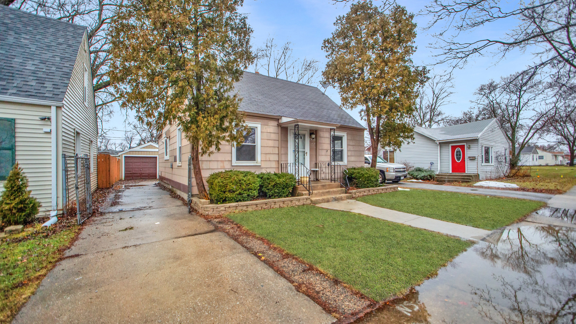 15014 Ridgeway Avenue Midlothian, IL 60445 - Photo 2 of 18 a front view of a house with a yard and garage